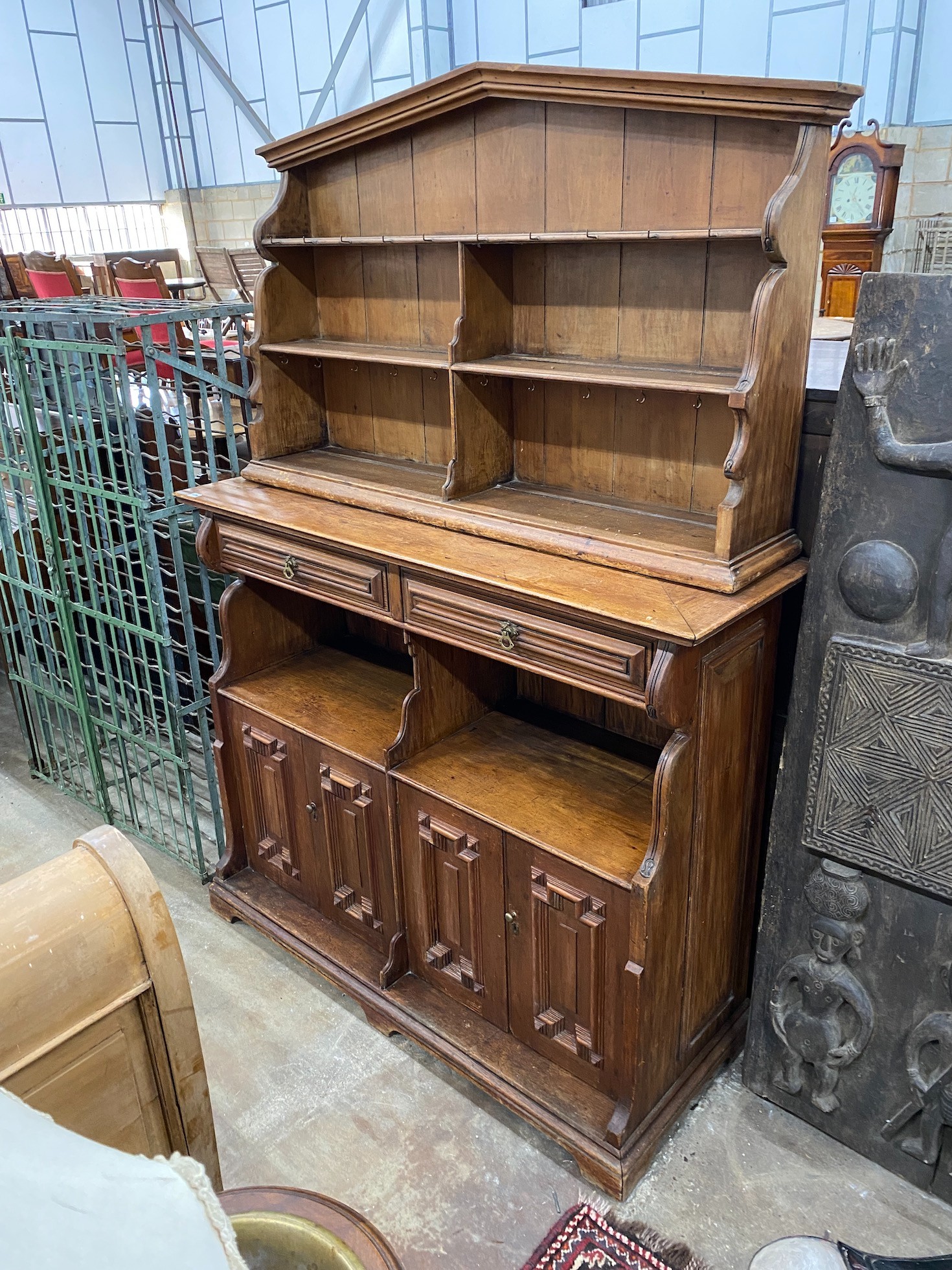 An Arts and Crafts pine buffet with arched top, width 150cm, depth 46cm, height 205cm